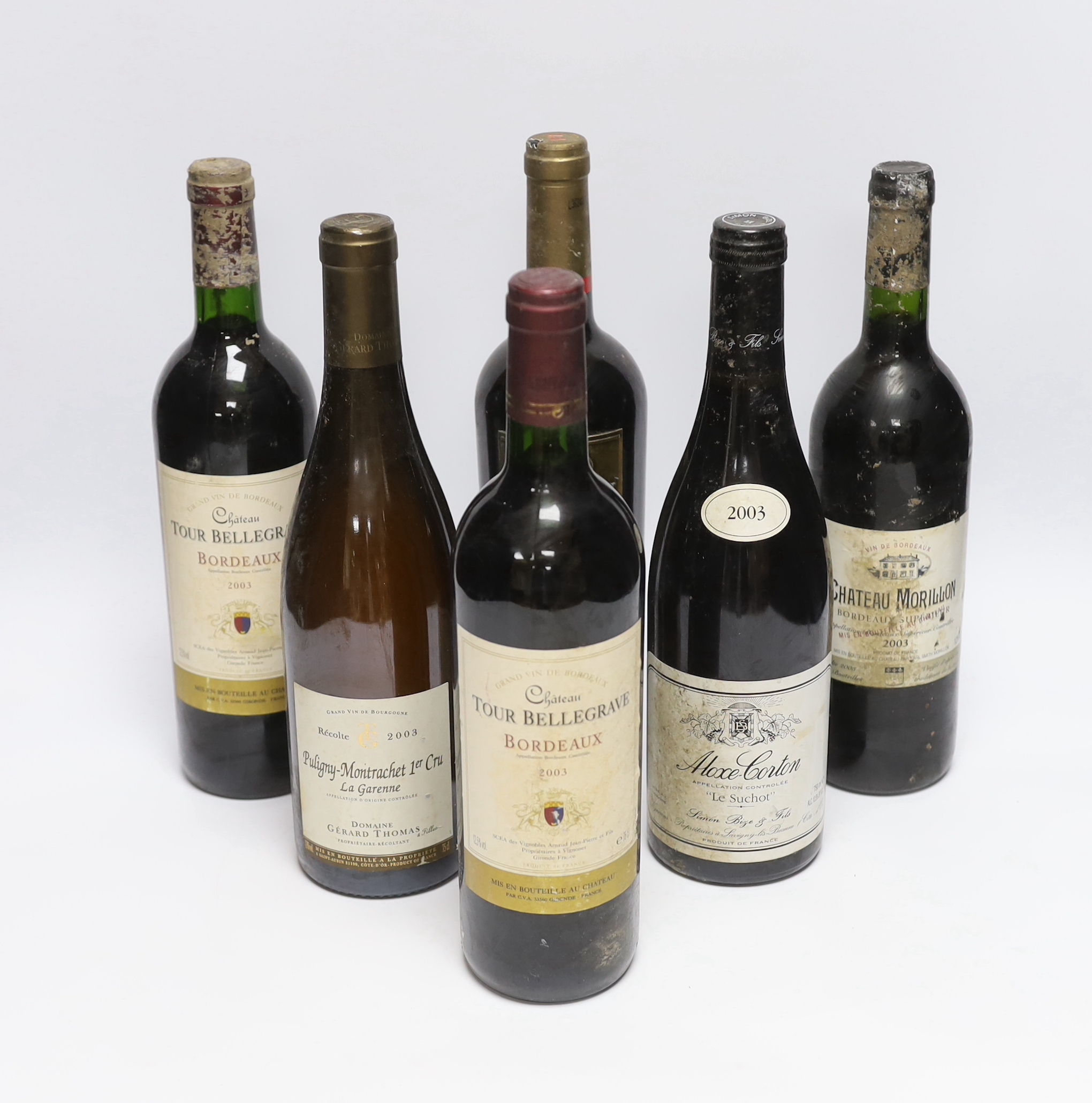 Six bottles of red wine - two bottles of Chateau Tour Bellegrave 2003, a bottle of Baron De Ley Rioja, a bottle of Simon Bize Aloxe Corton Le Suchot 2003, a bottle of Gérard Thomas Puligny-Montrachet La Garenne 2003 and